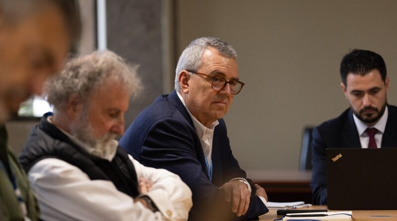 A man sitting at a conference table.