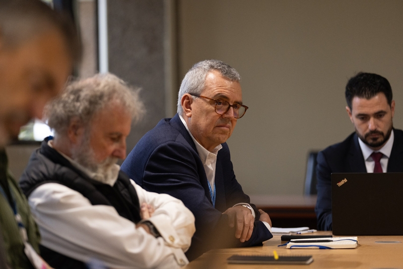 A man sitting at a conference table.